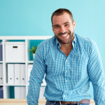 Businessman leaning on desk