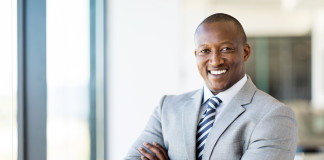 african american office worker with arms folded