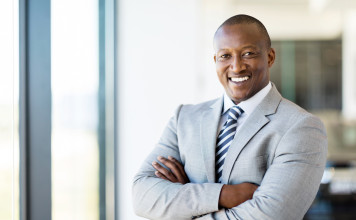 african american office worker with arms folded