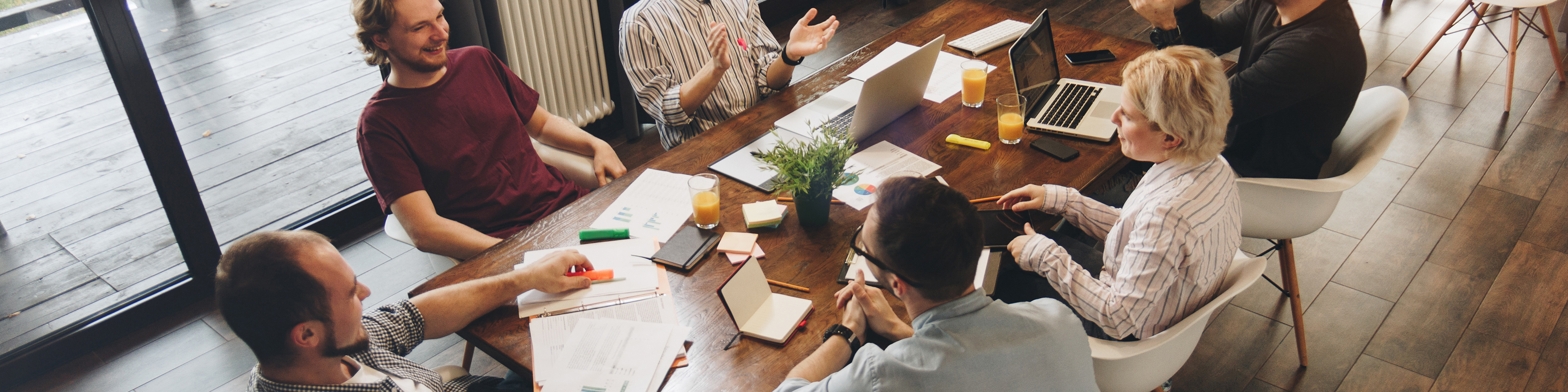 Coworking meeting. Group business people sits around table and w