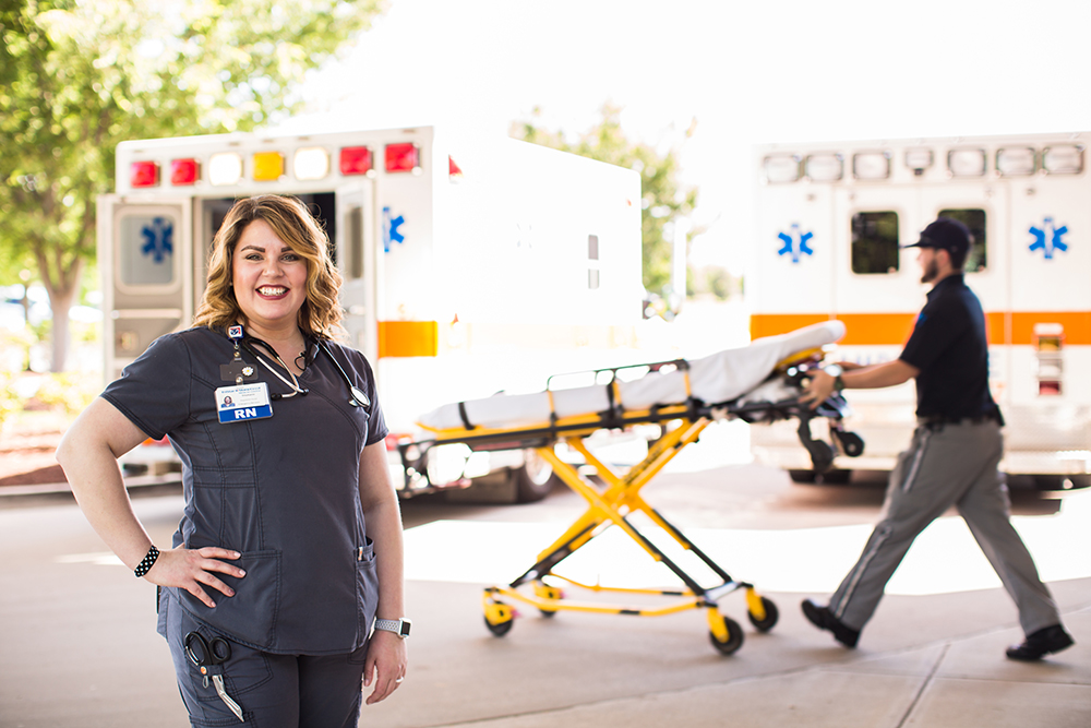 female nurse stading in front of paramedic ambulance