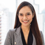 Portrait of smiling Asian businesswoman standing in the office